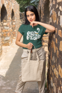 t shirt mockup of a woman holding a tote bag by a stone arch m25843 (1) (medium) (small)